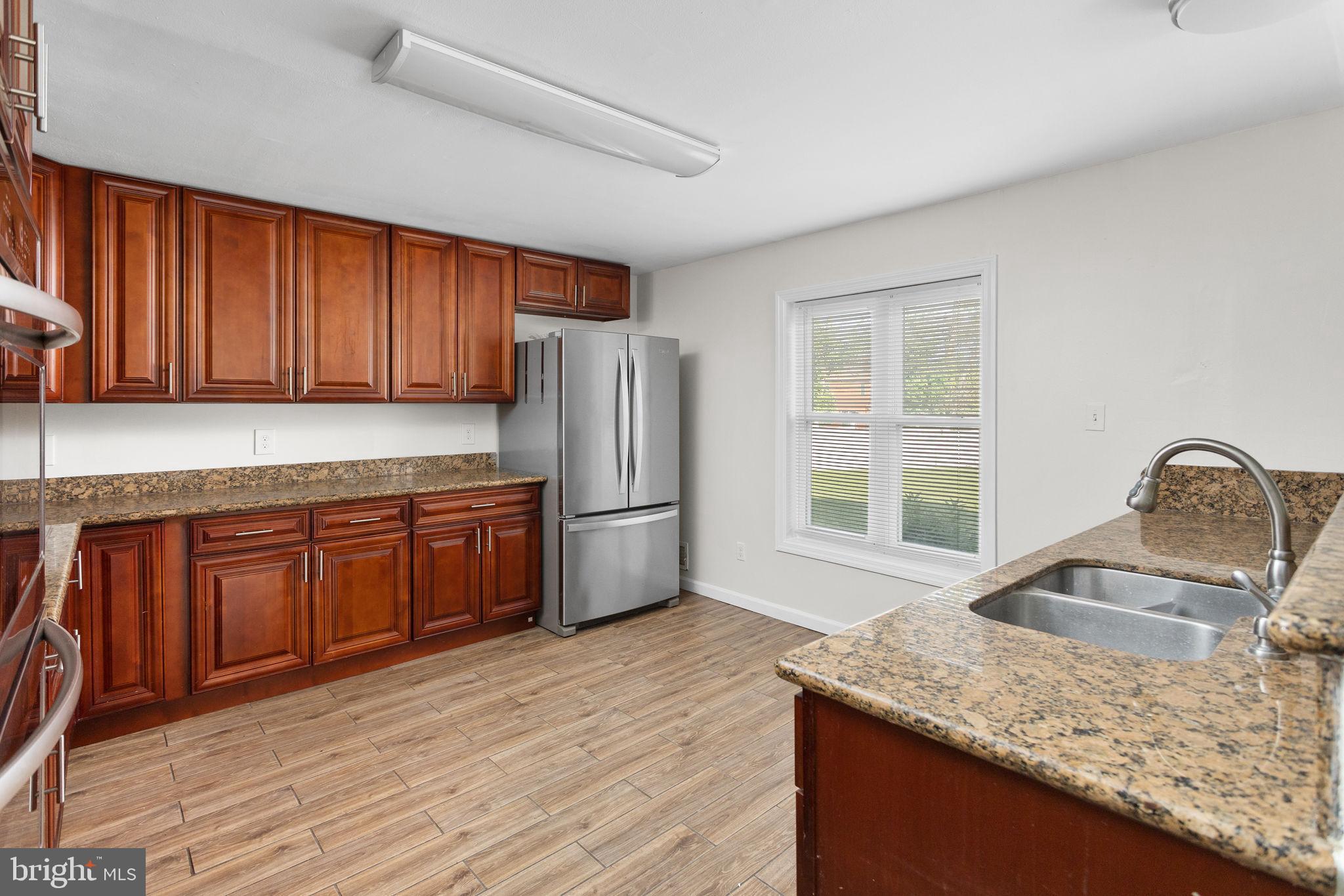 2264 Pennington Road Trenton, NJ 08638 - Photo 9 of 24 a kitchen with granite countertop a sink stove and refrigerator
