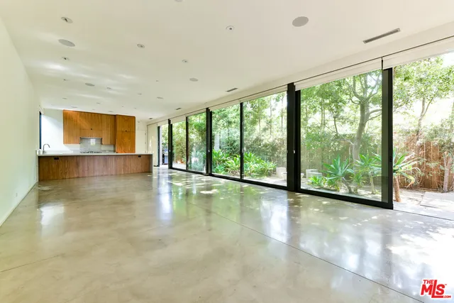 a view of a kitchen with wooden floor and a large window