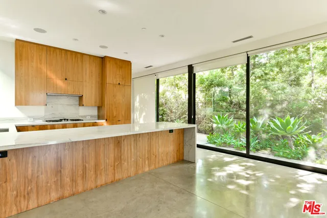 a room with large windows and a table