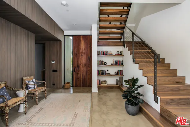 a bathroom with a granite countertop toilet sink and mirror