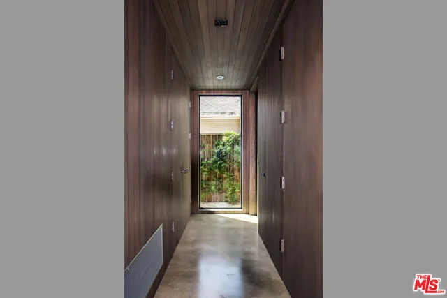 a spacious bedroom with a bed and a large window