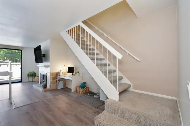 a bedroom with a bed and large windows