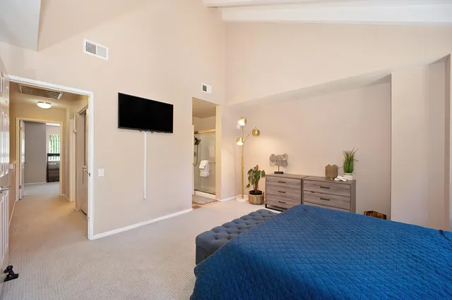 a spacious bathroom with a granite countertop sink and a mirror