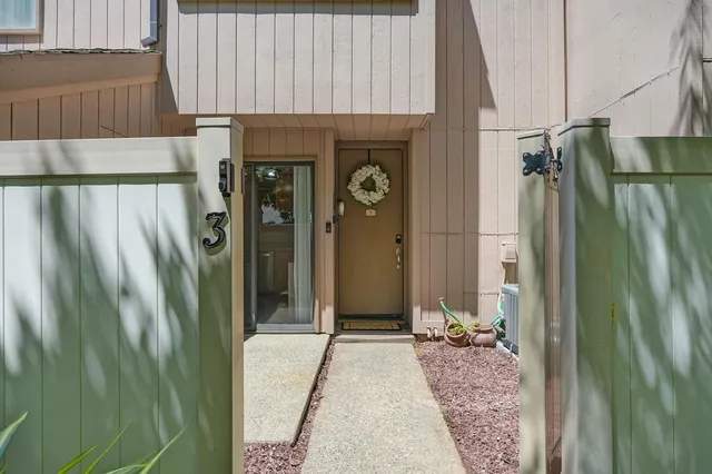 a view of a hallway with wooden floor and a window