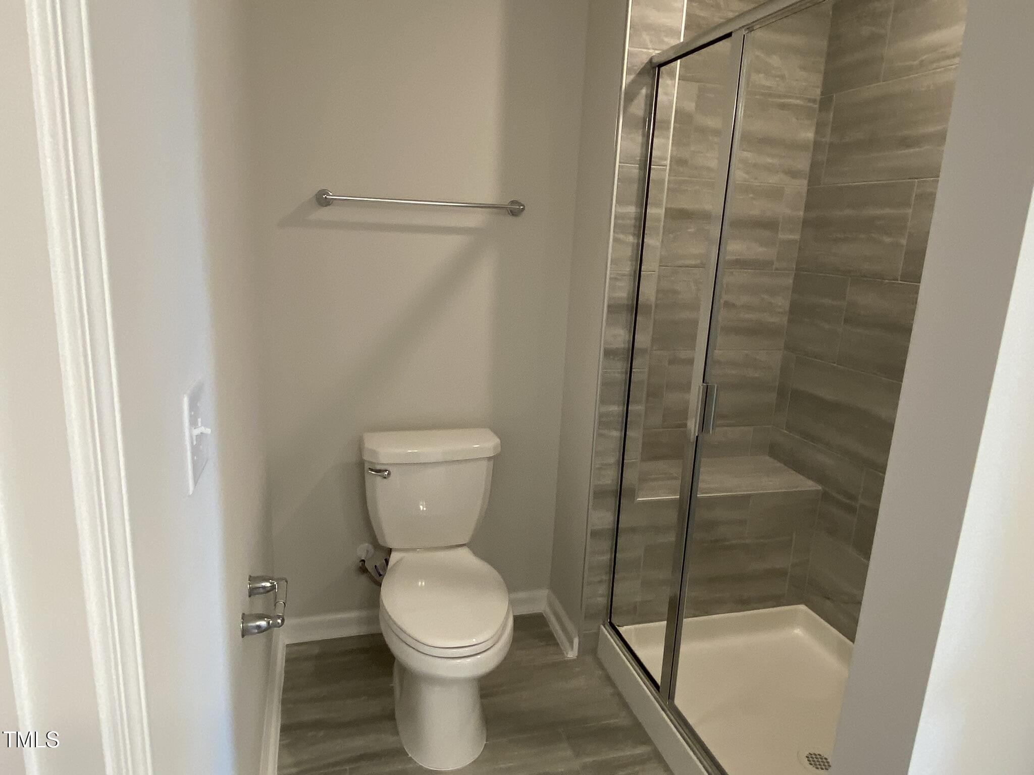 722 Gimari Drive Wake Forest, NC 27587 - Photo 18 of 25 a bathroom with a toilet and shower