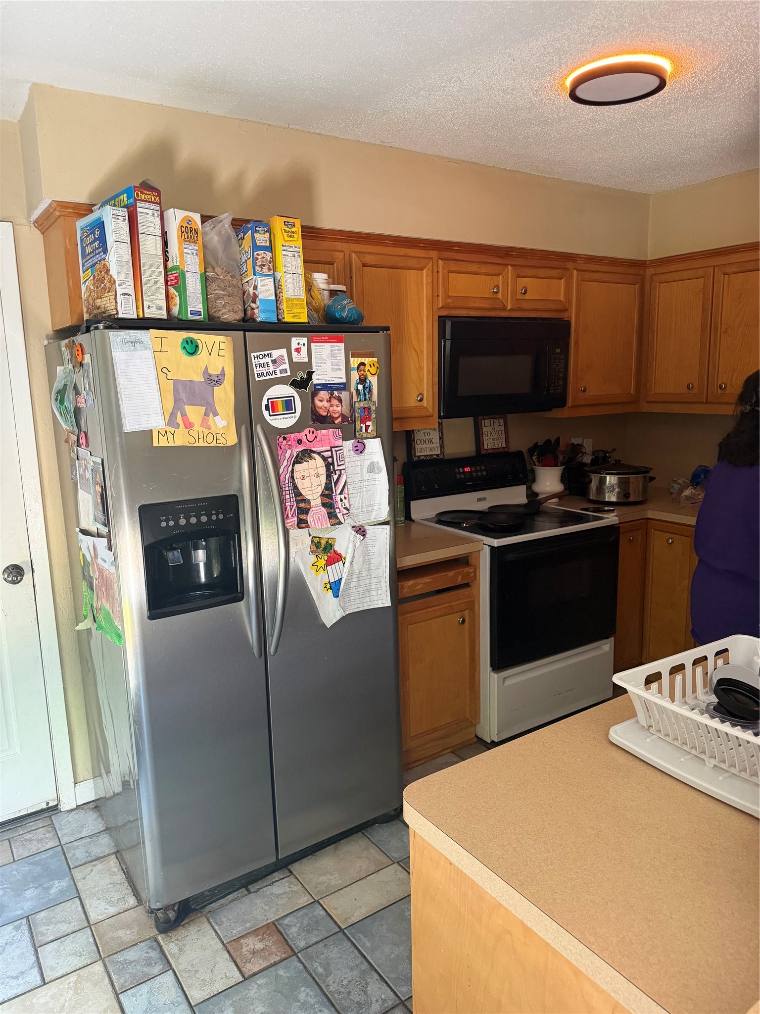 411 South Austin Street Webster, TX 77598 - Photo 13 of 13 a kitchen with stainless steel appliances granite countertop a refrigerator a stove and a sink with wooden floor