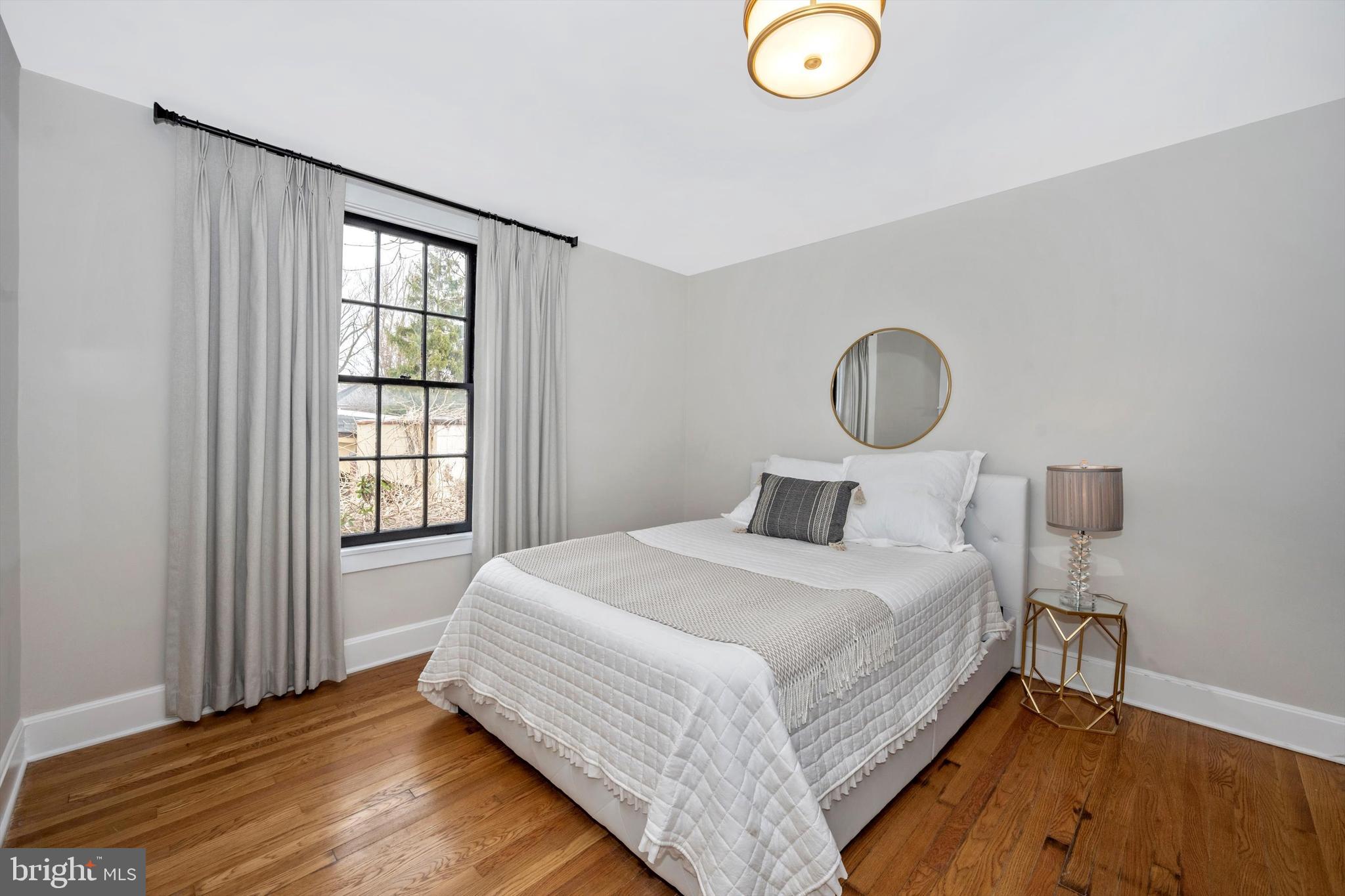 125 West Church Street, Unit B Frederick, MD 21701 - Photo 25 of 60 a bedroom with a bed and a window