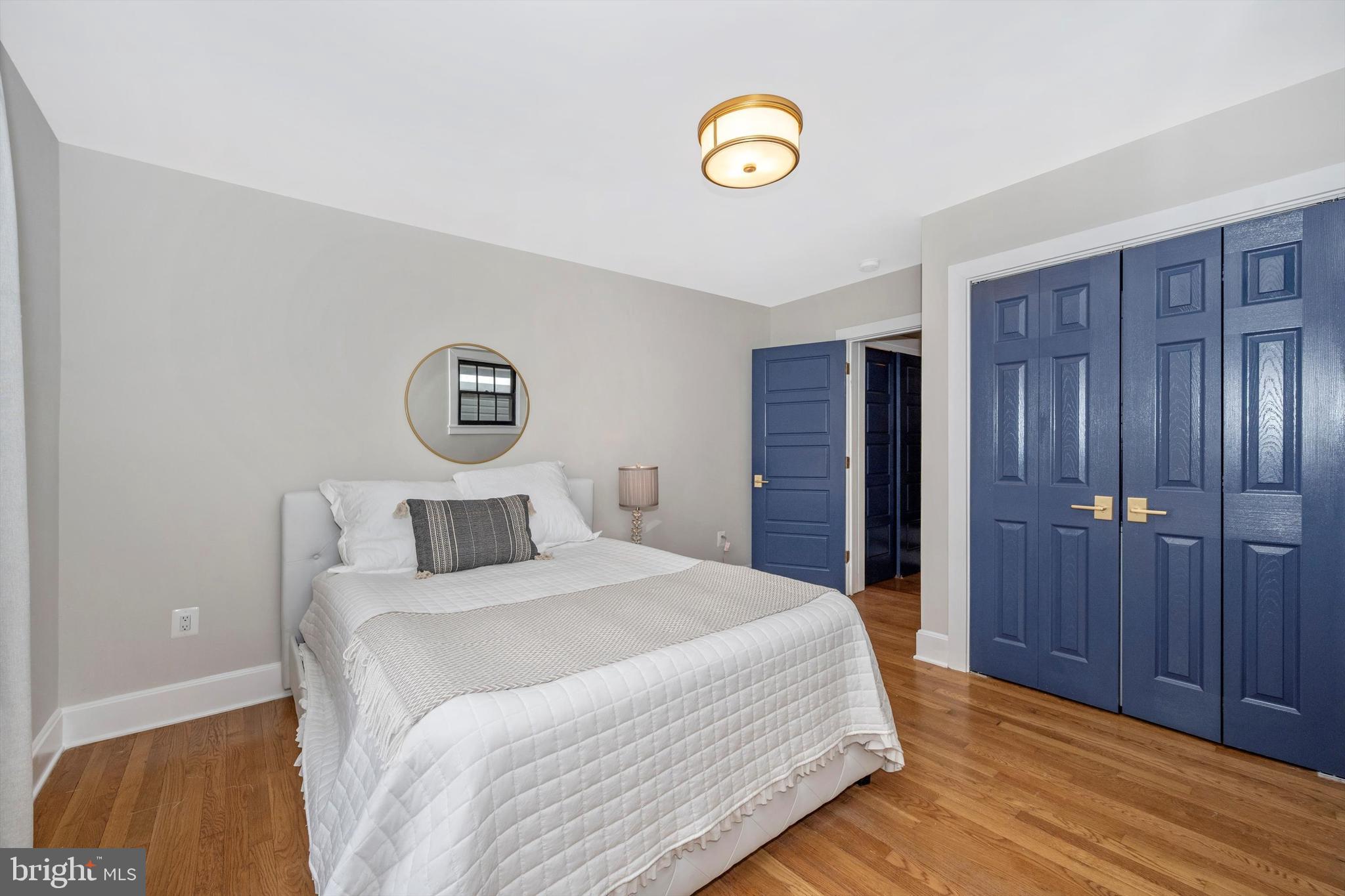 125 West Church Street, Unit B Frederick, MD 21701 - Photo 26 of 60 a bedroom with a bed and a chandelier