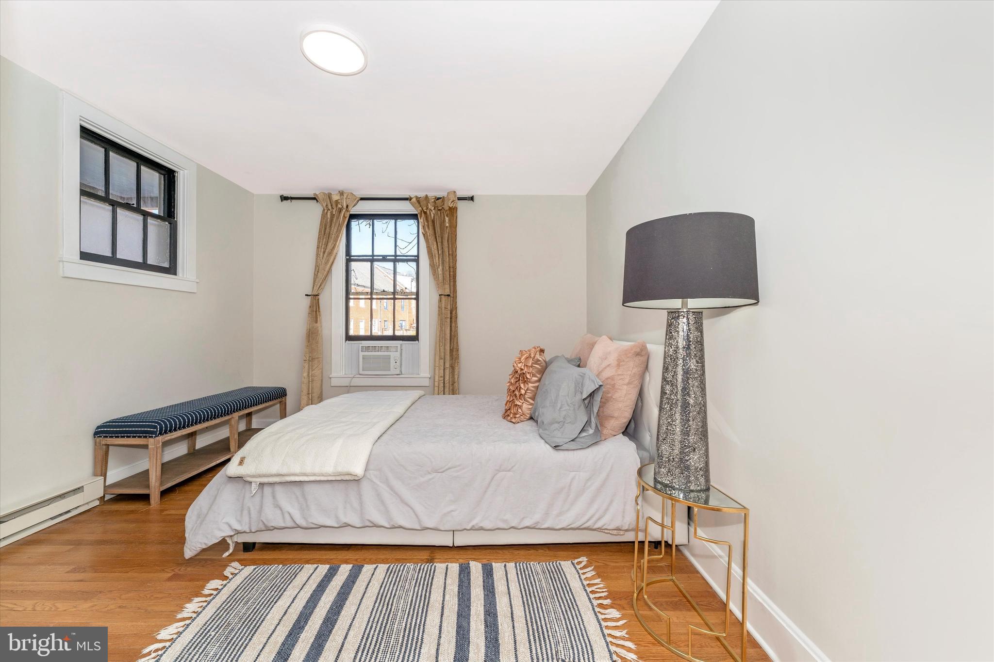 125 West Church Street, Unit B Frederick, MD 21701 - Photo 27 of 60 a bedroom with a bed and a night stand