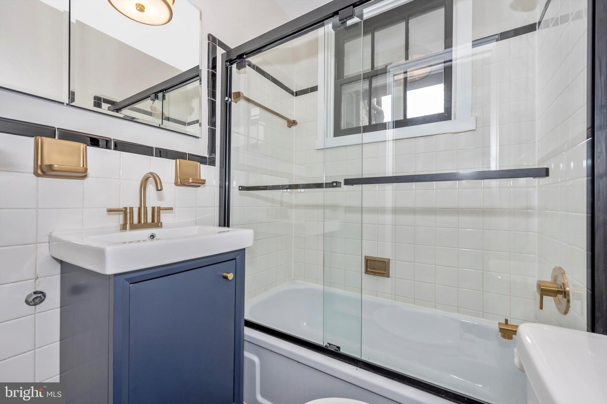 125 West Church Street, Unit B Frederick, MD 21701 - Photo 29 of 60 a bathroom with a sink and mirror with bathtub