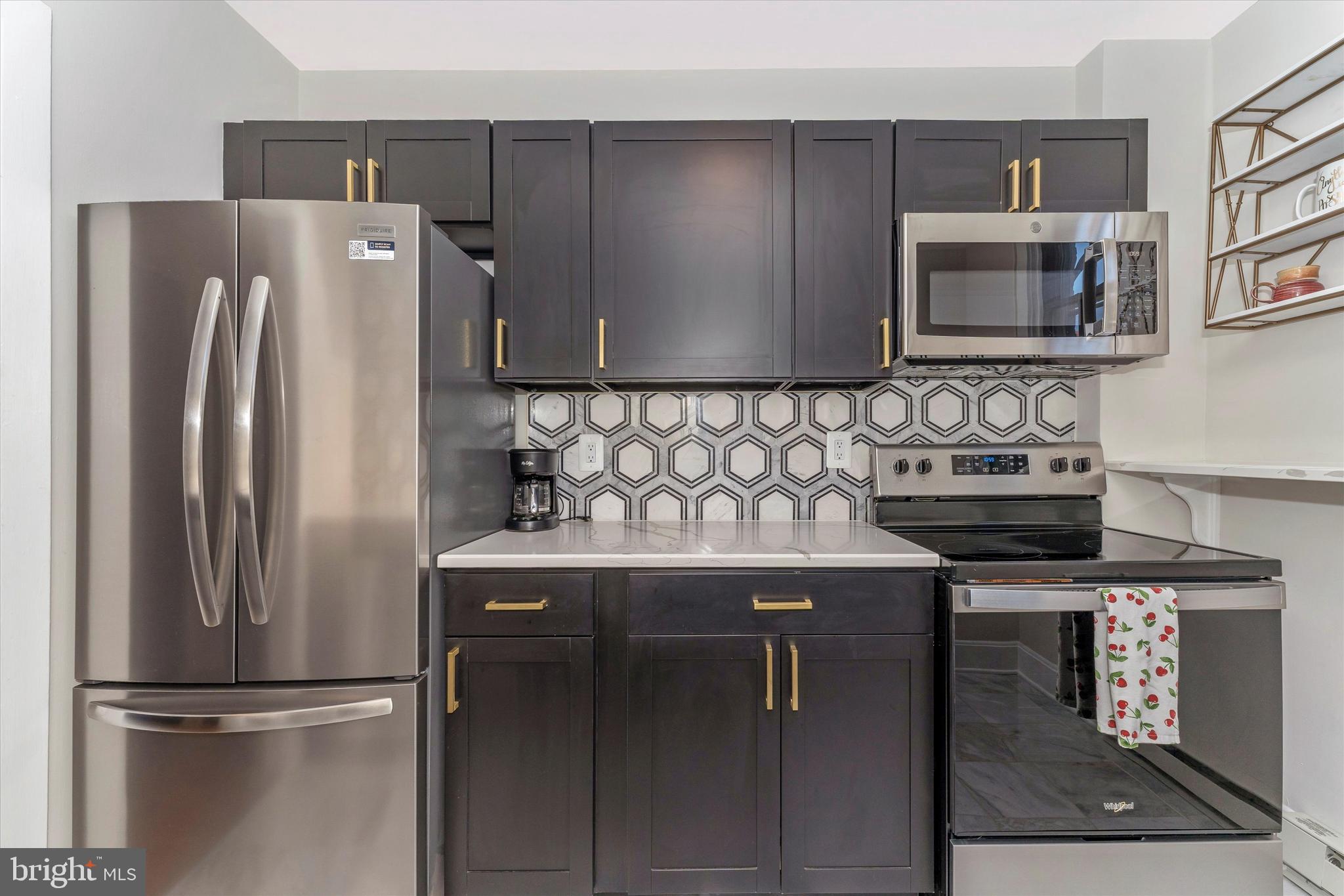 125 West Church Street, Unit B Frederick, MD 21701 - Photo 33 of 60 a kitchen with stainless steel appliances granite countertop a refrigerator and a stove