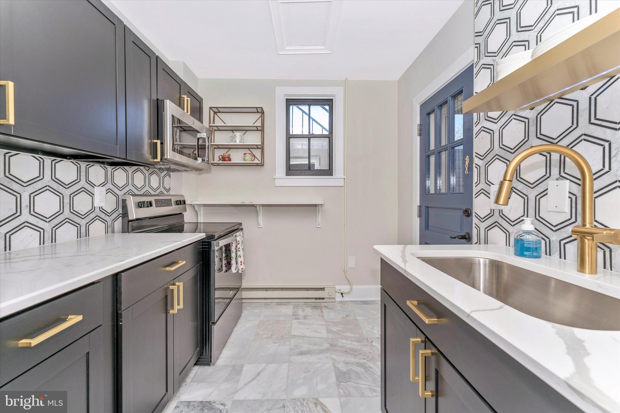 125 West Church Street, Unit B Frederick, MD 21701 - Photo 38 of 60 a kitchen with stainless steel appliances granite countertop a sink stove and cabinets