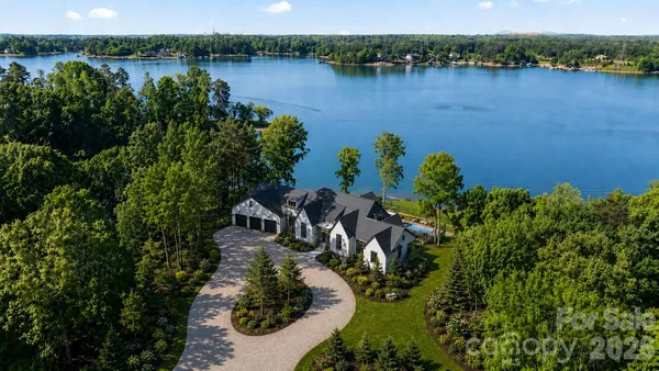 a kitchen with stainless steel appliances kitchen island granite countertop a table chairs and a refrigerator