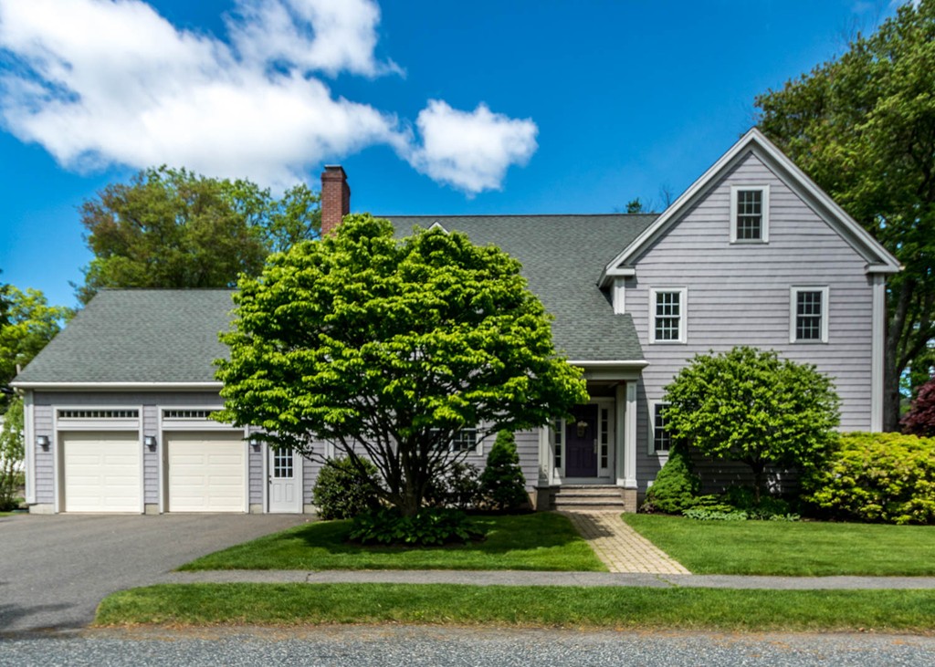 a front view of a house with a yard and garage