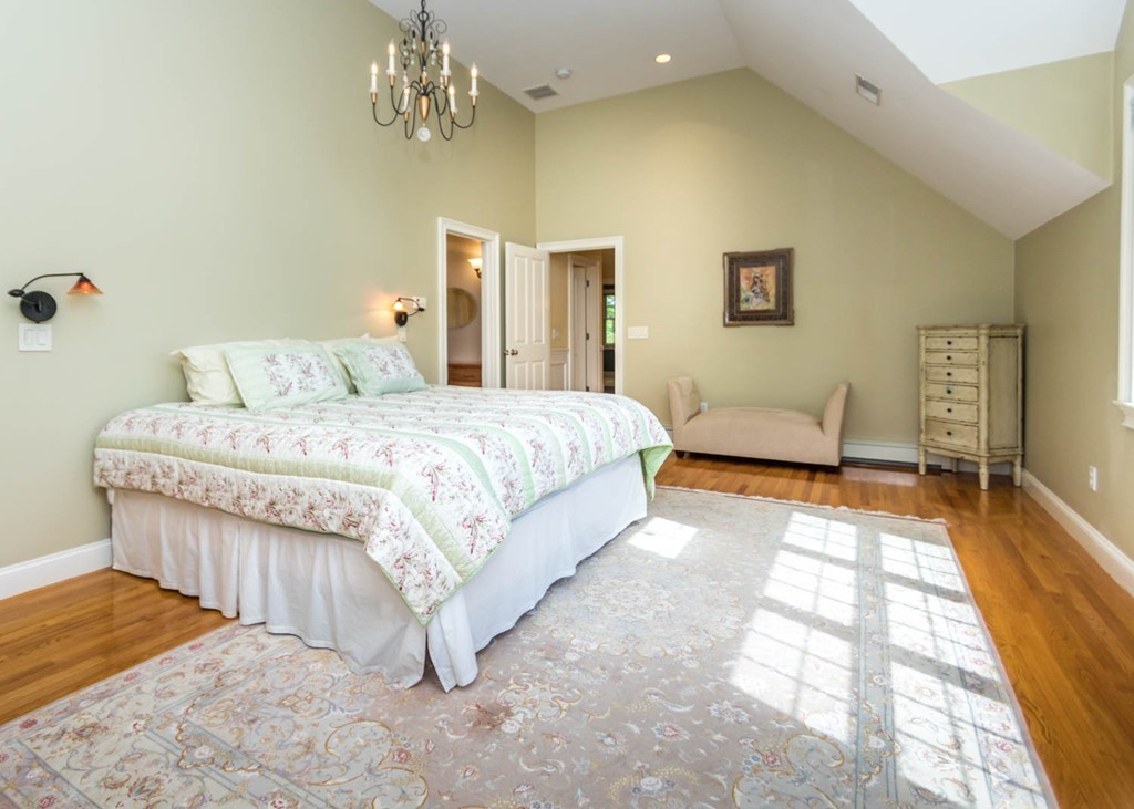 65 Avalon Road Needham, MA 02492 - Photo 16 of 30 a bedroom with a bed and a chandelier