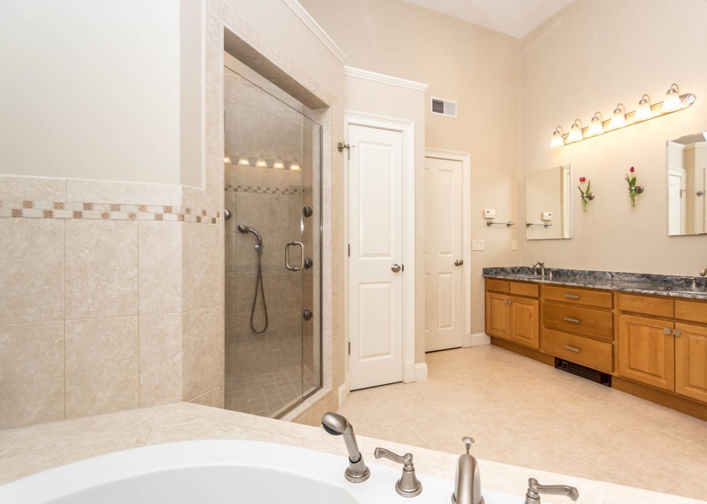 65 Avalon Road Needham, MA 02492 - Photo 17 of 30 a spacious bathroom with a granite countertop sink a mirror a bathtub and shower
