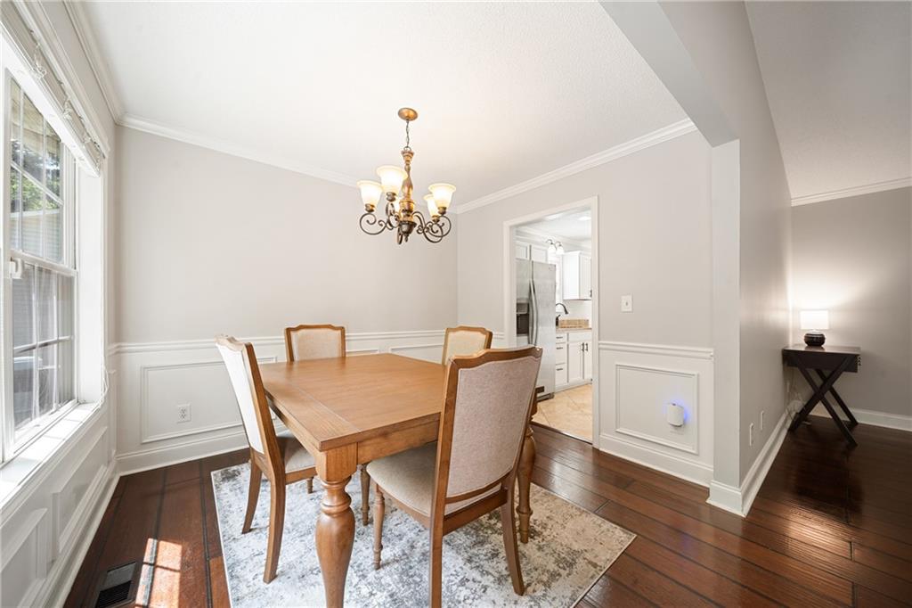 921 Pace Road Hiram, GA 30141 - Photo 8 of 41 a view of a dining room with furniture a chandelier and wooden floor