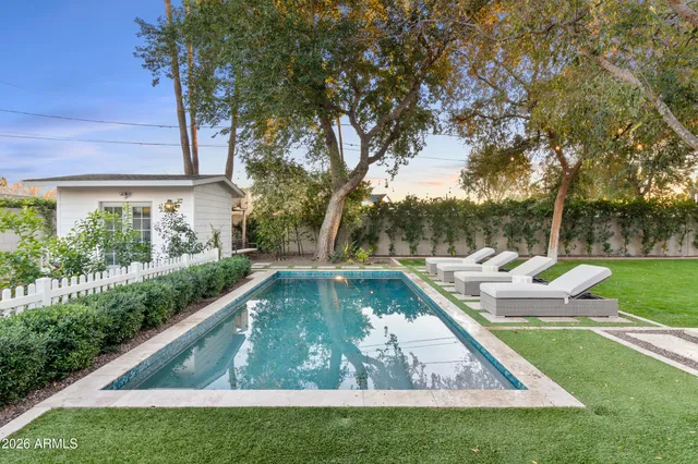 a view of yard with swimming pool and green space