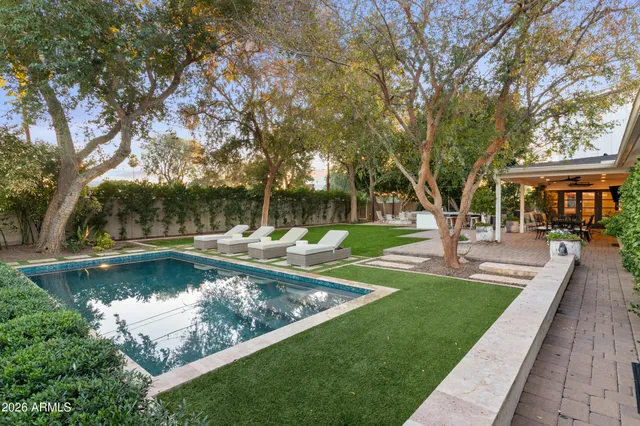 front view of a house with swimming pool and sitting area