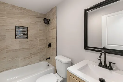 a bathroom with a sink a toilet and a bathtub