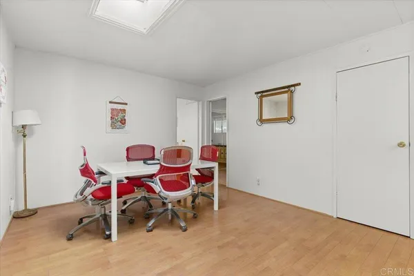 a dining room with furniture and wooden floor