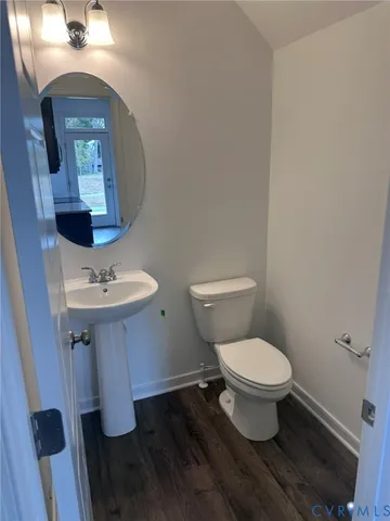 a bathroom with a sink toilet and a mirror