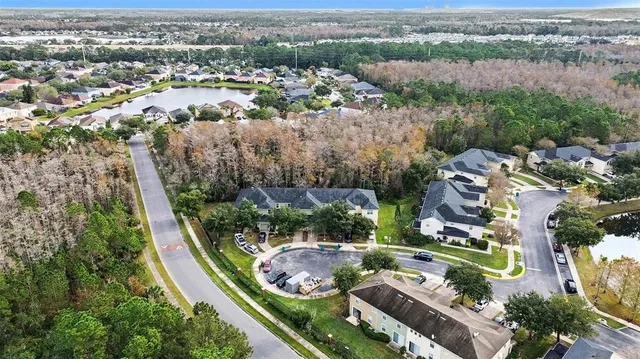 an aerial view of residential houses with outdoor space and street view