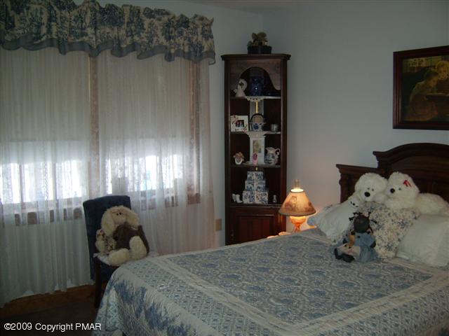 107 Fox Chase Road Stroudsburg, PA 18360 - Photo 13 of 28 a bedroom with a bed and a chandelier