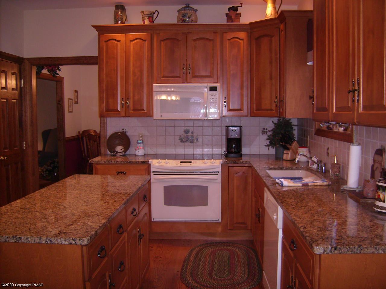 107 Fox Chase Road Stroudsburg, PA 18360 - Photo 2 of 28 a kitchen with stainless steel appliances granite countertop a stove a sink and a microwave