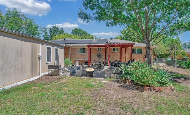 a view of a patio with a table and chairs and potted plants