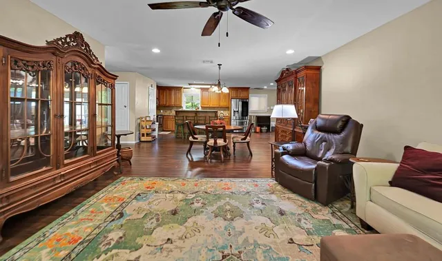 a living room with furniture ceiling fan and a rug