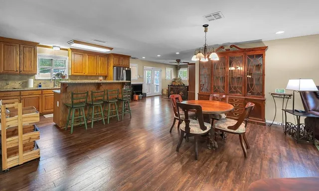 a view of a dining room with furniture and wooden floor