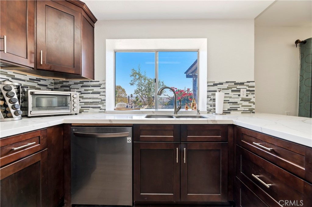 4144 Shellicia Circle Riverside, CA 92509 - Photo 12 of 33 a kitchen with a sink and cabinets