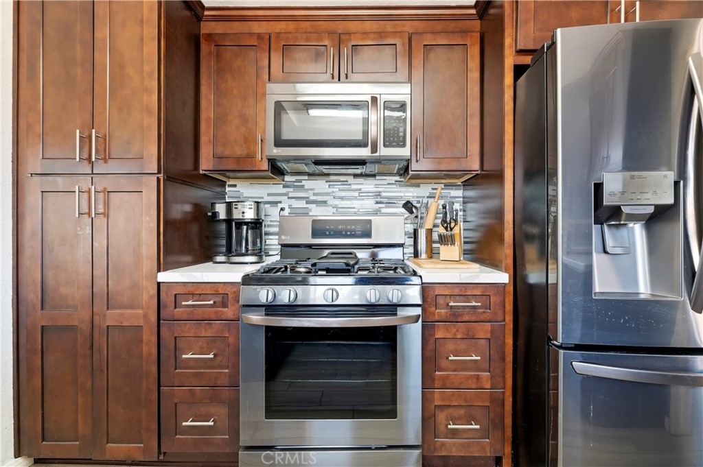 4144 Shellicia Circle Riverside, CA 92509 - Photo 13 of 33 a kitchen with stainless steel appliances granite countertop a stove microwave and refrigerator