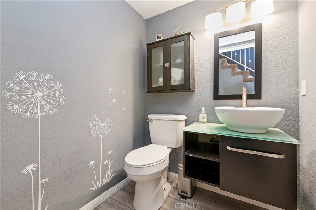 4144 Shellicia Circle Riverside, CA 92509 - Photo 16 of 33 a bathroom with a toilet a sink and mirror