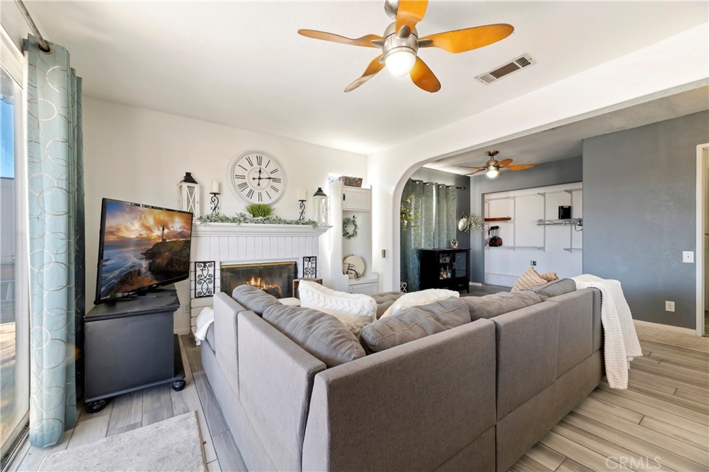 4144 Shellicia Circle Riverside, CA 92509 - Photo 20 of 33 a living room with furniture a fireplace and a flat screen tv