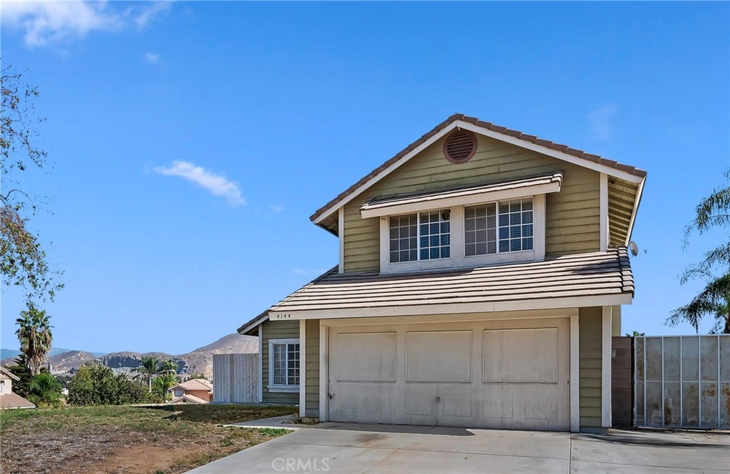 4144 Shellicia Circle Riverside, CA 92509 - Photo 2 of 33 a front view of a house with a yard