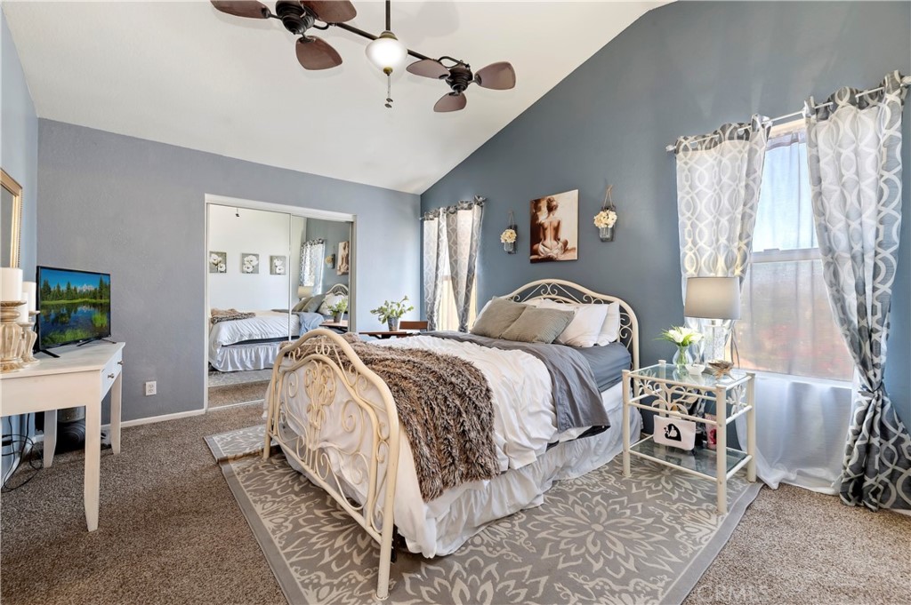 4144 Shellicia Circle Riverside, CA 92509 - Photo 25 of 33 a spacious bedroom with a bed and a chandelier