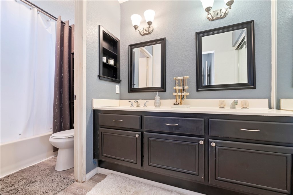 4144 Shellicia Circle Riverside, CA 92509 - Photo 26 of 33 a bathroom with a toilet sink and mirror
