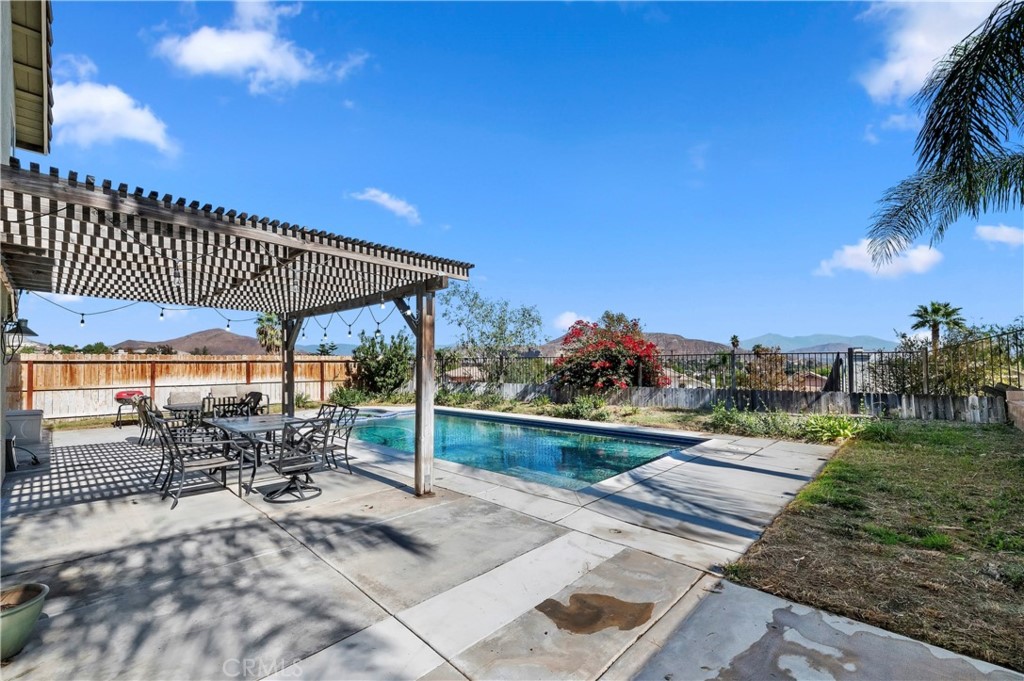 4144 Shellicia Circle Riverside, CA 92509 - Photo 28 of 33 a view of a patio with table and chairs with wooden floor and fence