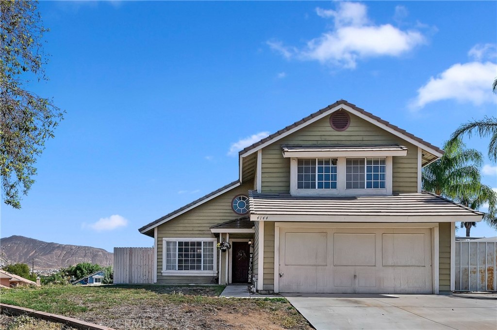 4144 Shellicia Circle Riverside, CA 92509 - Photo 3 of 33 a front view of a house with a yard