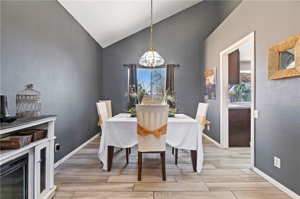 4144 Shellicia Circle Riverside, CA 92509 - Photo 10 of 33 a dining room with furniture a chandelier and wooden floor