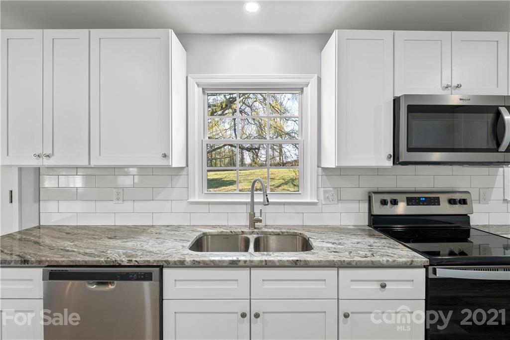 955 Potneck Road Salisbury, NC 28147 - Photo 2 of 28 a kitchen with granite countertop a sink stainless steel appliances and cabinets