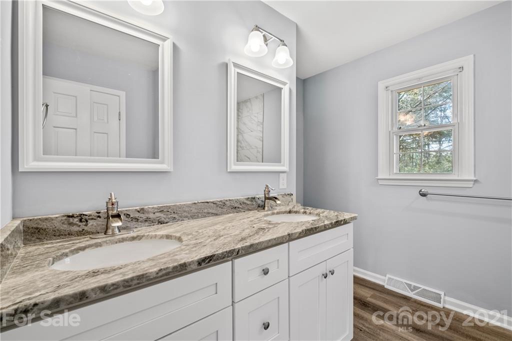 955 Potneck Road Salisbury, NC 28147 - Photo 13 of 28 a bathroom with a granite countertop sink and a window