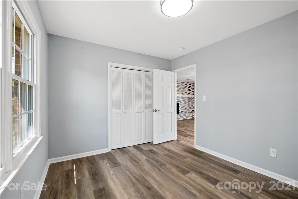 955 Potneck Road Salisbury, NC 28147 - Photo 16 of 28 a view of an empty room with wooden floor and a window
