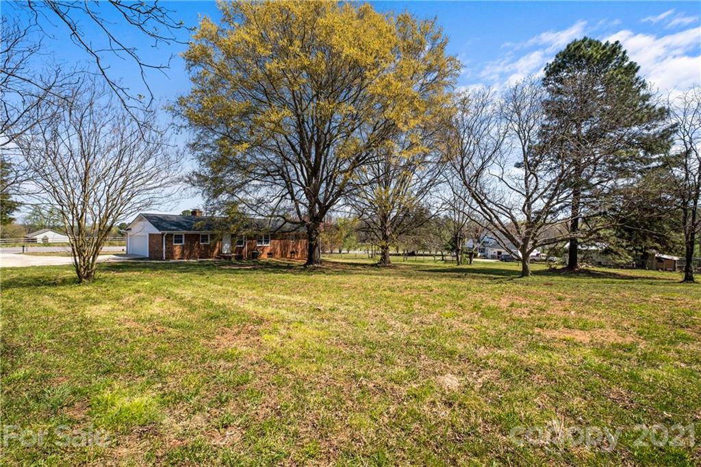 955 Potneck Road Salisbury, NC 28147 - Photo 26 of 28 a brick house with trees in front of it