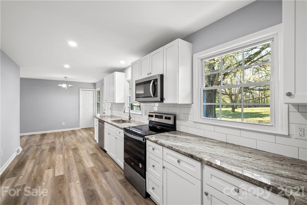 955 Potneck Road Salisbury, NC 28147 - Photo 4 of 28 a kitchen with a sink a window and stainless steel appliances