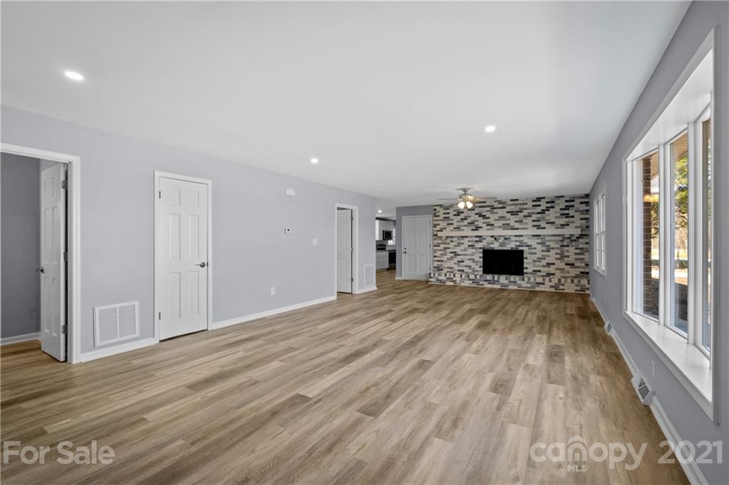 955 Potneck Road Salisbury, NC 28147 - Photo 5 of 28 a view of empty room with wooden floor and fireplace