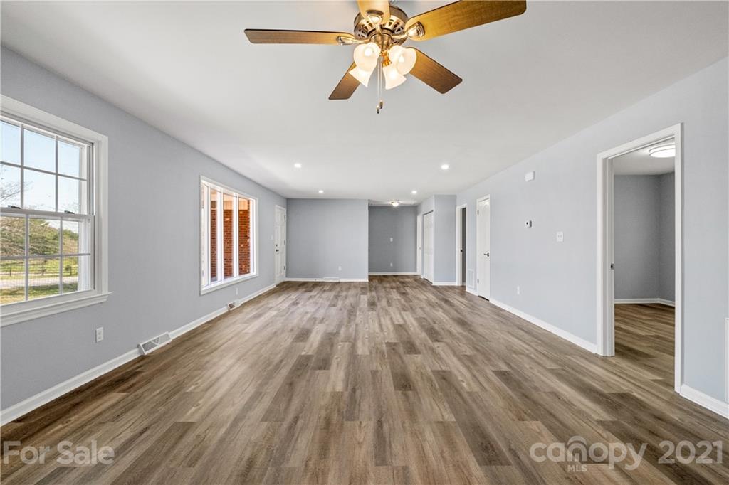 955 Potneck Road Salisbury, NC 28147 - Photo 7 of 28 a view of empty room with wooden floor and fan