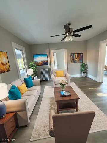 a living room with furniture and a wooden floor